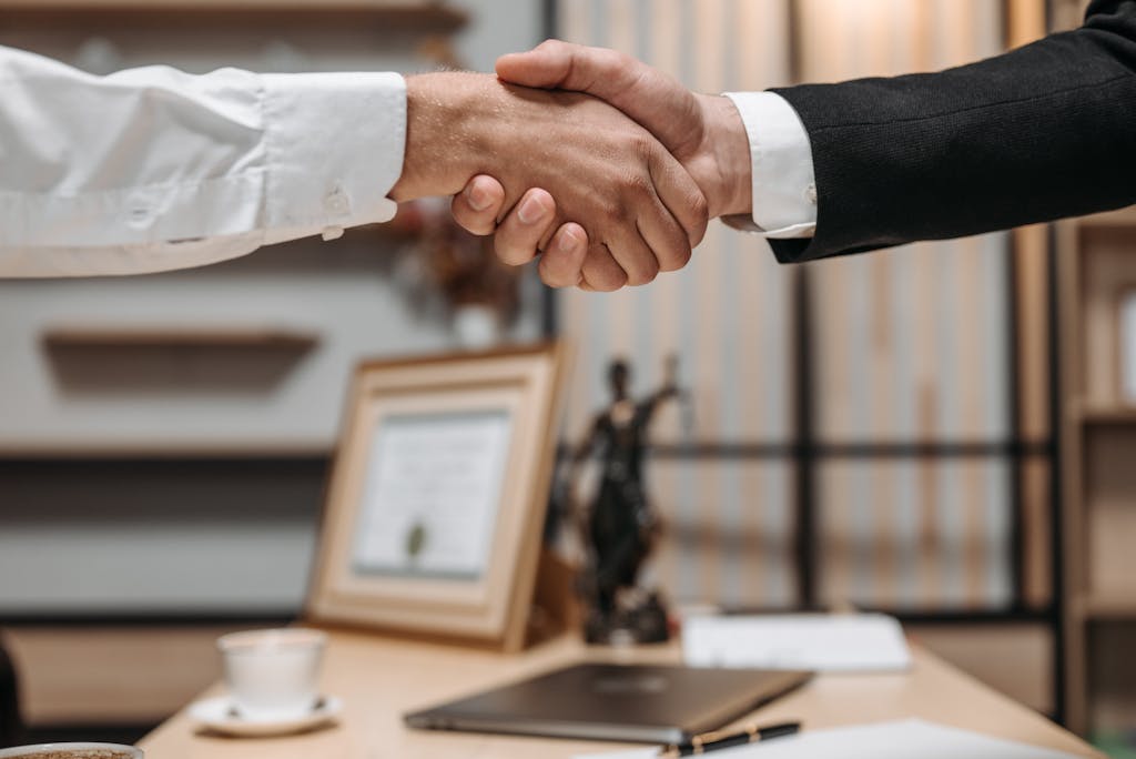 close up of a handshake between two professionals in a modern office setting emphasizing partnership and agreement. 8112172